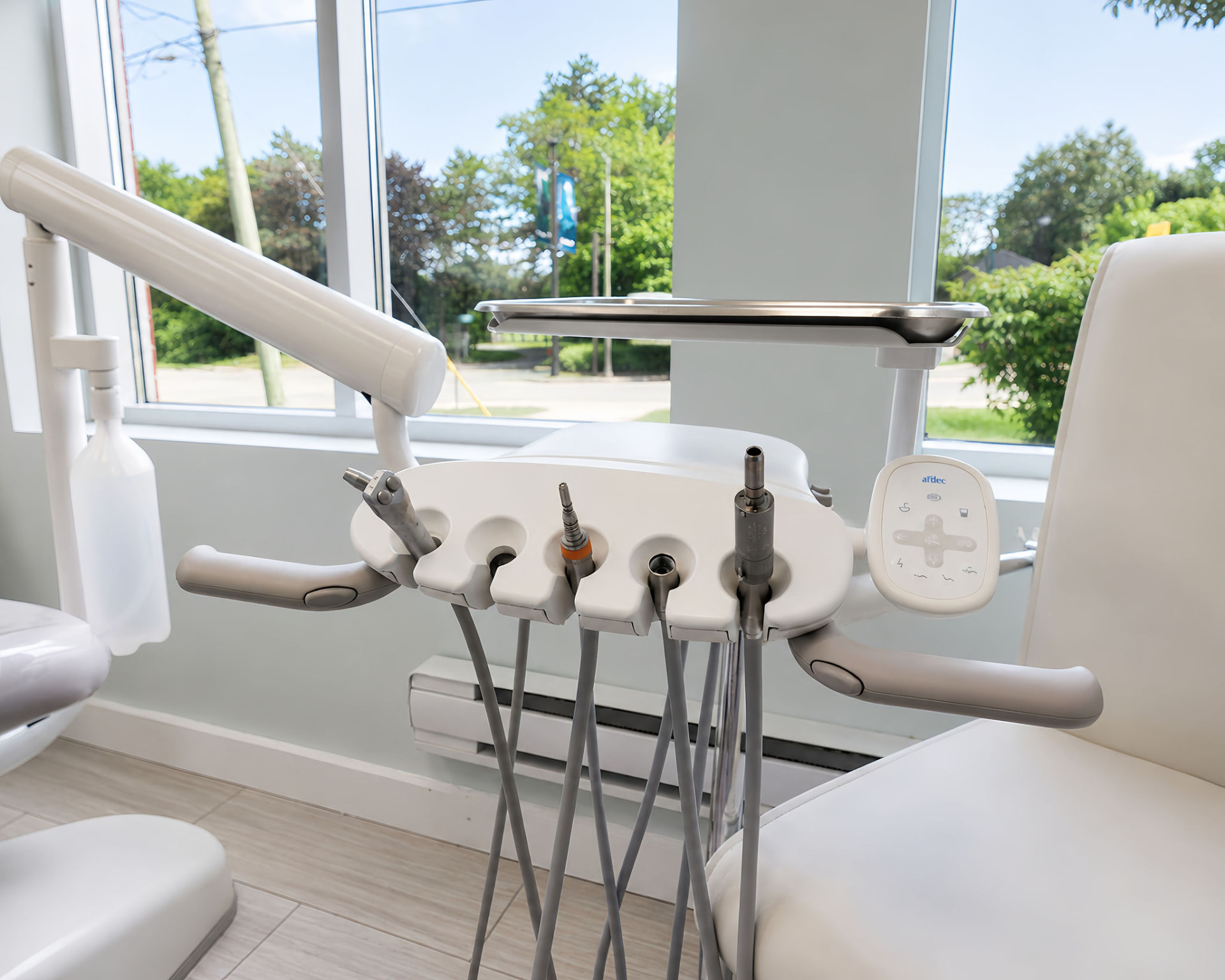 A-dec dental delivery unit and handpieces in a treatment room