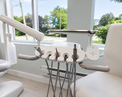 A-dec dental delivery unit and handpieces in a treatment room