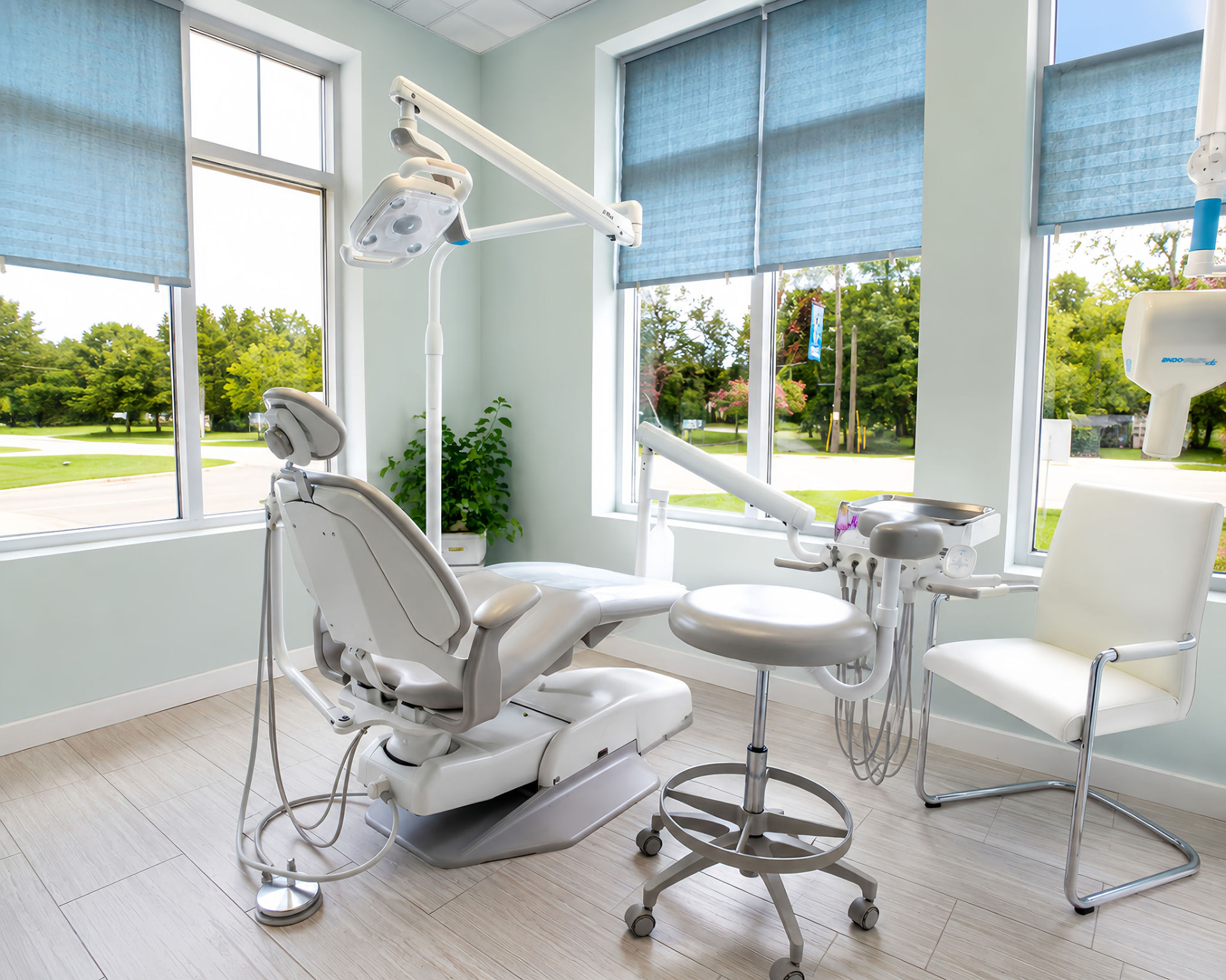 Dental operatory with blue window shades and modern equipment