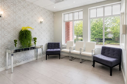 Sunlit patient waiting room with comfortable seating