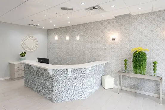 Front desk and patterned feature wall in the clinic lobby